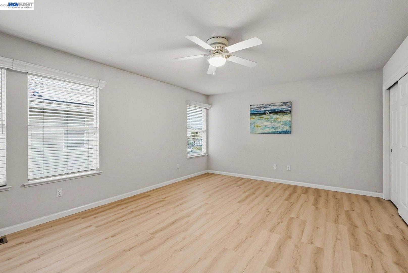 663 Clay Way Ripon, CA 95366 - Photo 31 of 43 a view of an empty room with wooden floor and a window