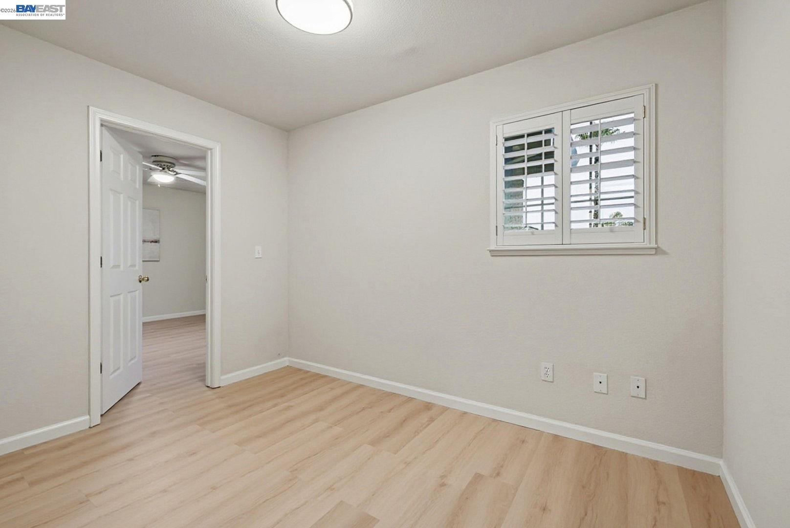 663 Clay Way Ripon, CA 95366 - Photo 33 of 43 an empty room with wooden floor and windows