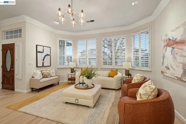 a living room with furniture and floor to ceiling windows