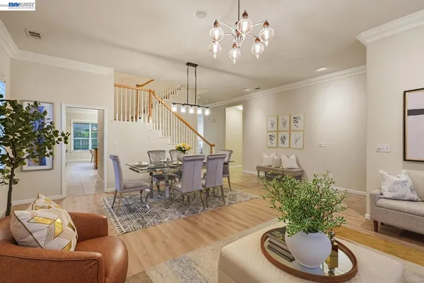 a living room with furniture potted plant and a chandelier