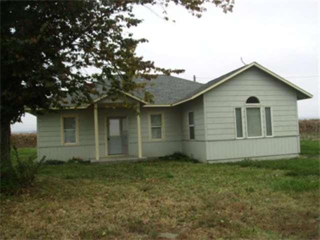 4051 Reeves Road Sunnyside, WA 98944 - Photo 1 of 9 front view of house with a yard