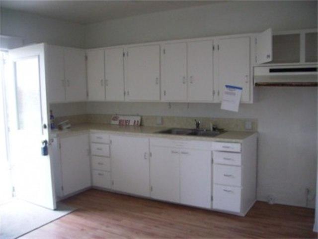 4051 Reeves Road Sunnyside, WA 98944 - Photo 4 of 9 a kitchen with granite countertop white cabinets and sink