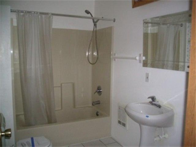 4051 Reeves Road Sunnyside, WA 98944 - Photo 6 of 9 a bathroom with a shower a mirror and a sink