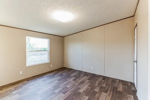 a view of a balcony with wooden floor next to a yard