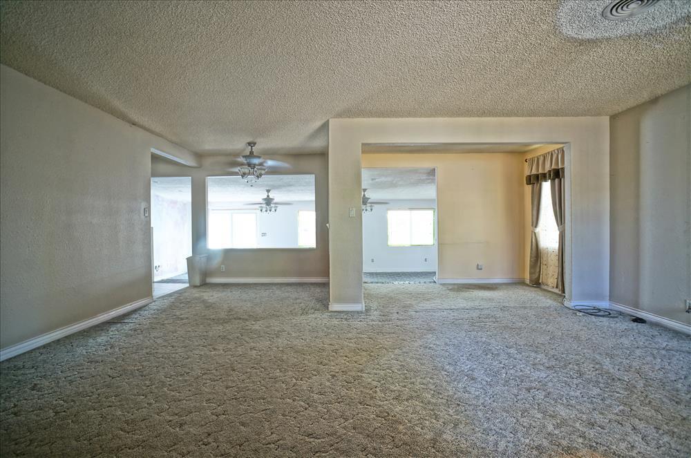43879 Fig Avenue Lancaster, CA 93534 - Photo 3 of 11 an empty room with a empty space and windows