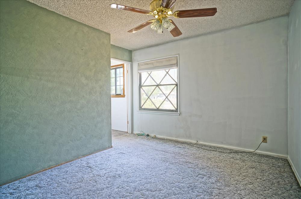 43879 Fig Avenue Lancaster, CA 93534 - Photo 7 of 11 an empty room with windows and fan