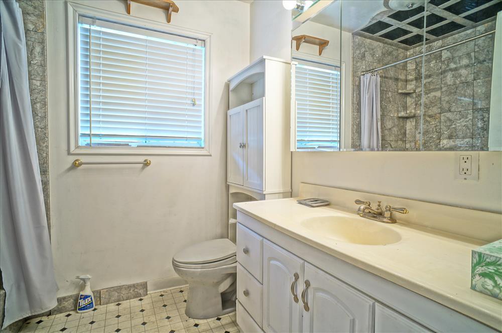 43879 Fig Avenue Lancaster, CA 93534 - Photo 10 of 11 a bathroom with a sink a toilet and shower