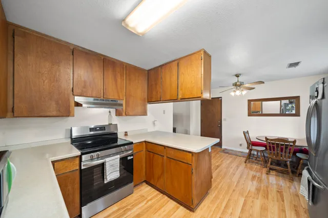a bathroom with a granite countertop sink a toilet and a mirror