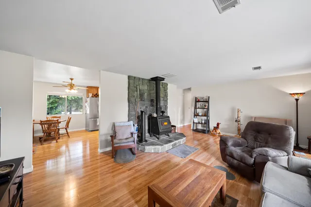 a living room with furniture a rug and a window