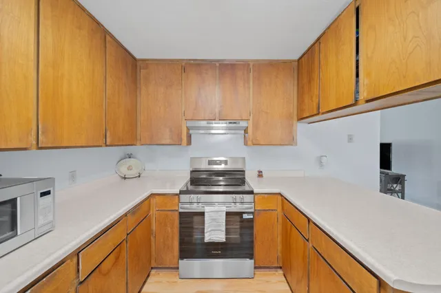 a bedroom with a bed a table and a window