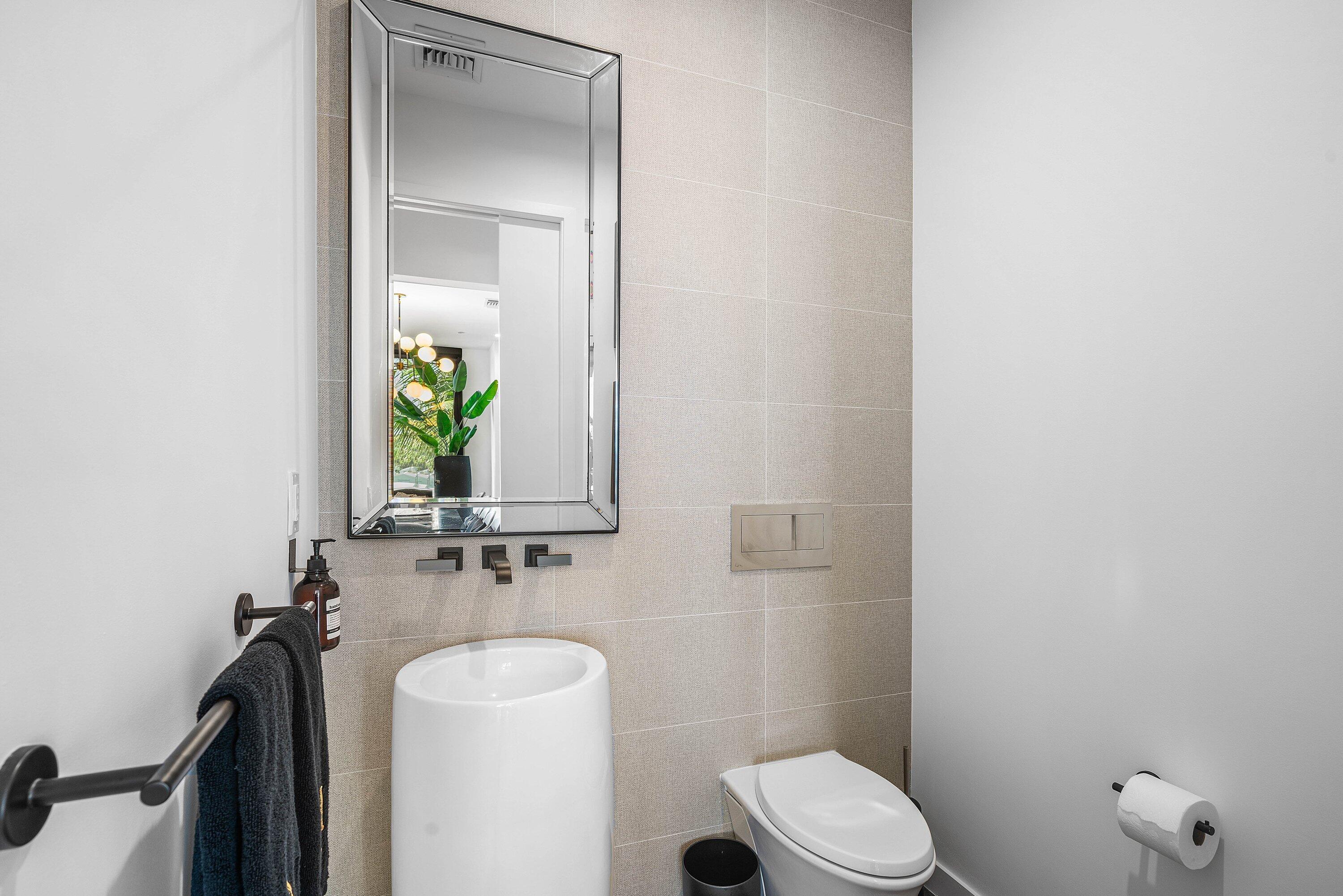 11501 Old Ocean Boulevard Ocean Ridge, FL 33435 - Photo 35 of 70 a bathroom with a toilet sink and mirror