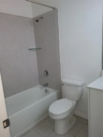 a bathroom with a toilet and a bath tub