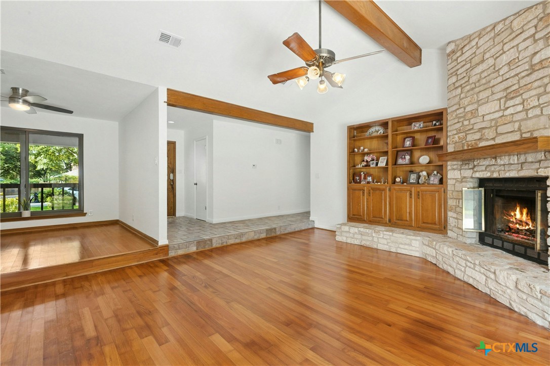 3502 Apache Forest Drive Austin, TX 78739 - Photo 12 of 34 a view of empty room with wooden floor and fireplace