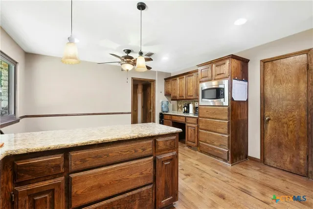 a view of a kitchen with a sink stainless steel appliances and cabinets