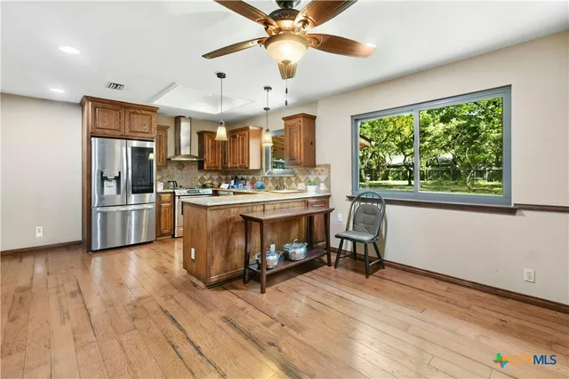 a kitchen with a stove a refrigerator and a microwave