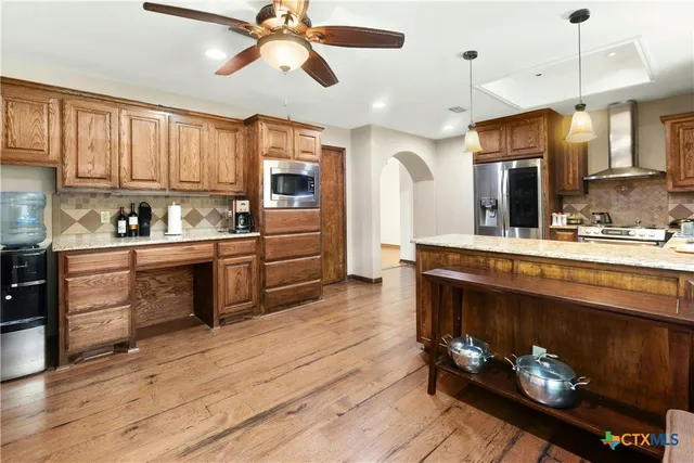 a kitchen with a sink cabinets and wooden floor