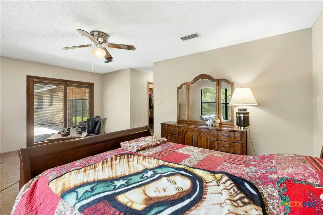 3502 Apache Forest Drive Austin, TX 78739 - Photo 23 of 34 a bed room with a bed and a mirror