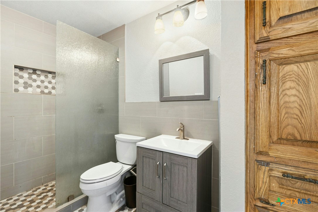 3502 Apache Forest Drive Austin, TX 78739 - Photo 28 of 34 a bathroom with a sink and a toilet