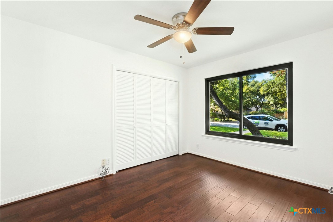 3502 Apache Forest Drive Austin, TX 78739 - Photo 29 of 34 an empty room with wooden floor and windows