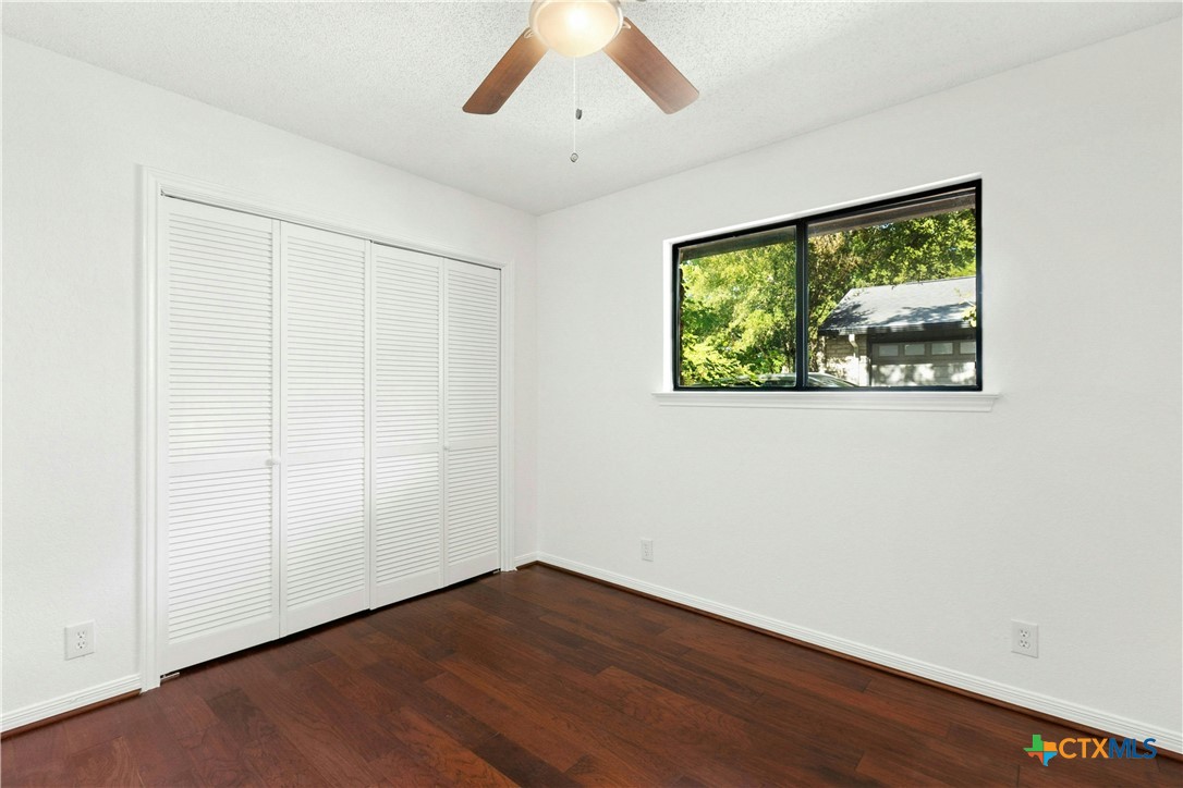 3502 Apache Forest Drive Austin, TX 78739 - Photo 34 of 34 an empty room with wooden floor and windows