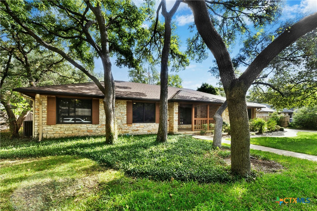 3502 Apache Forest Drive Austin, TX 78739 - Photo 4 of 34 a front view of a house with garden