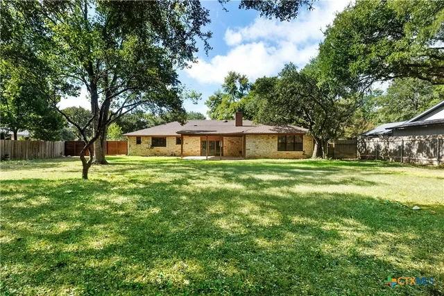 a front view of house with yard and trees
