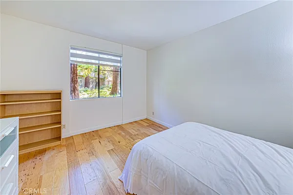 a bedroom with a bed and a night stand