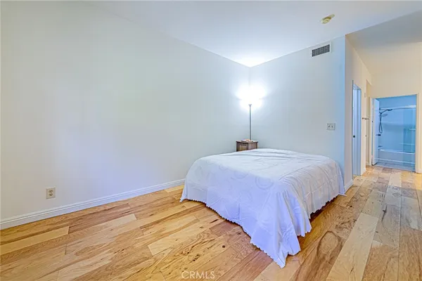 a view of bedroom and bedroom with wooden floor