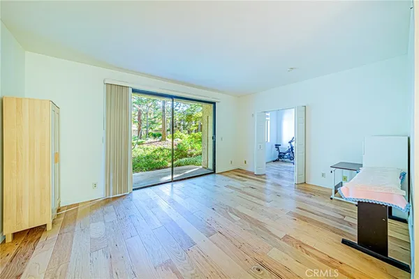a living room with a flat screen tv and floor to ceiling window