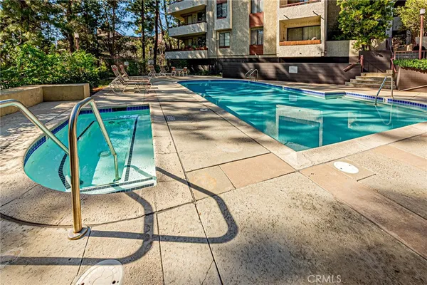 swimming pool view with a seating space