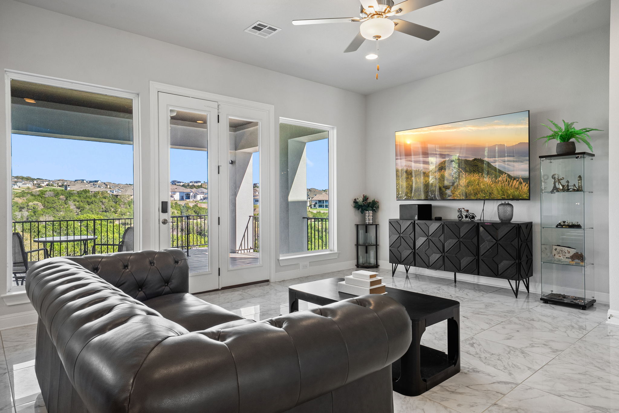 2132 Novara Trail Leander, TX 78641 - Photo 23 of 40 Living room with ceiling fan and light marble finish floors
