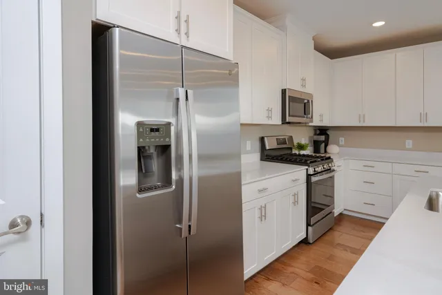 a kitchen with stainless steel appliances cabinets and a refrigerator