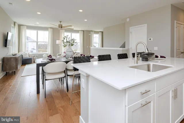 a large white kitchen with a table and chairs