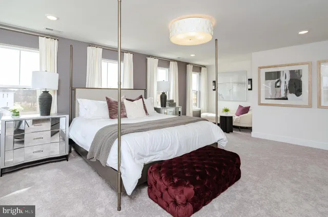 a bedroom with a large bed and a chandelier