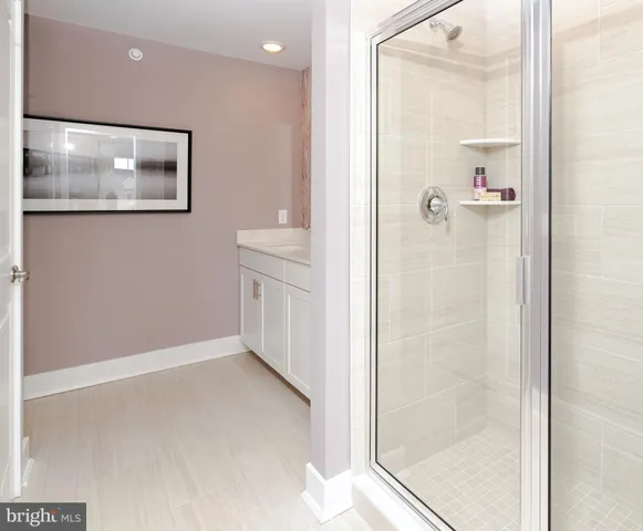 a bathroom with double vanity sinks and a mirror