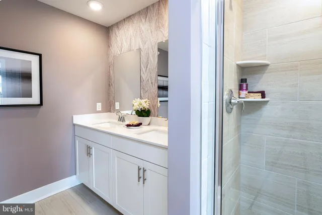 a room with stainless steel appliances furniture a rug and a window