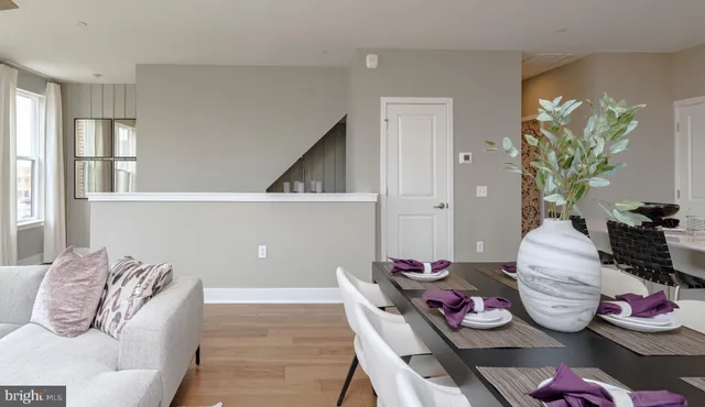 a living room with furniture and flowers