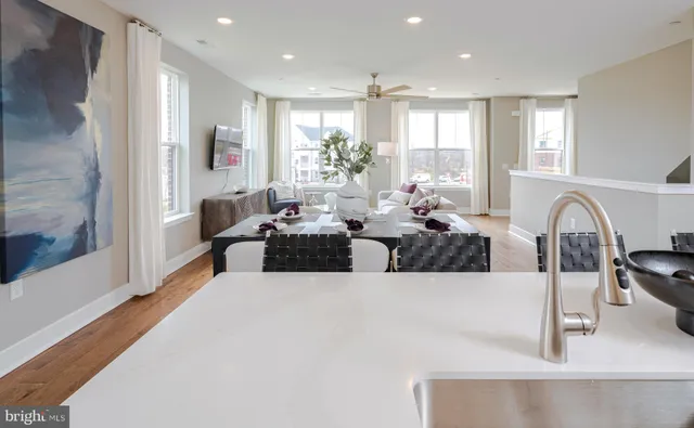 a living room with furniture potted plant and a large window