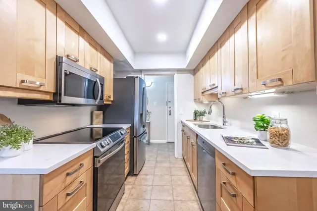 a kitchen with stainless steel appliances granite countertop a sink and a stove