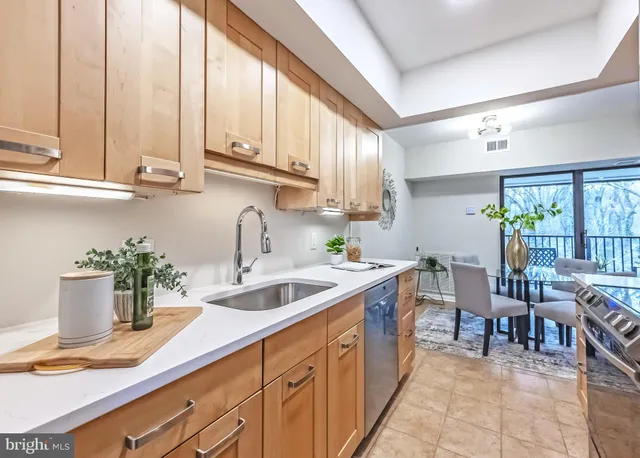 a kitchen with stove a sink and cabinets