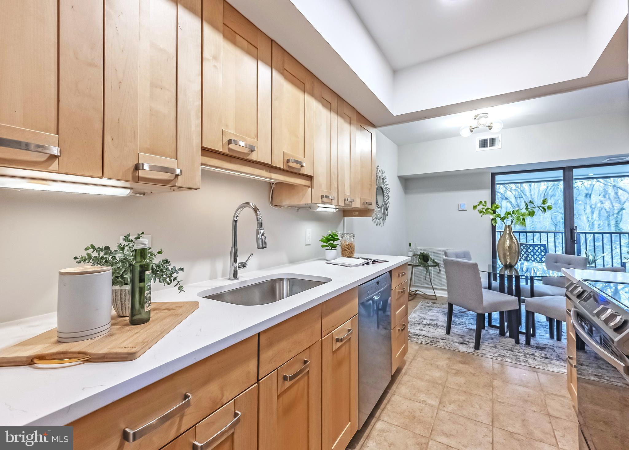 11657 Stoneview Square, Unit 97/22C Reston, VA 20191 - Photo 12 of 28 a kitchen with stove a sink and cabinets
