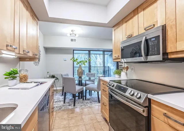 a kitchen that has a sink and a stove in it