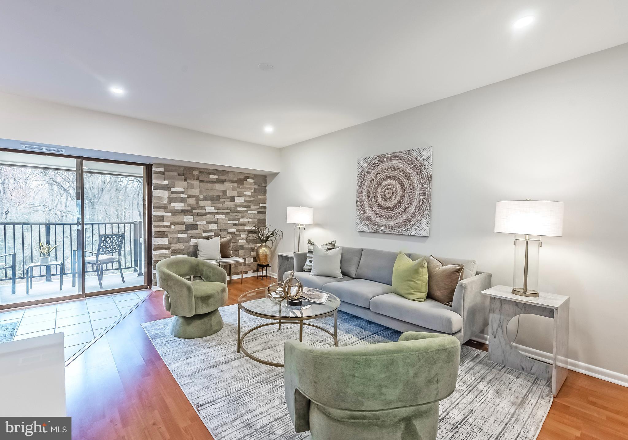 11657 Stoneview Square, Unit 97/22C Reston, VA 20191 - Photo 3 of 28 a living room with furniture and a large window