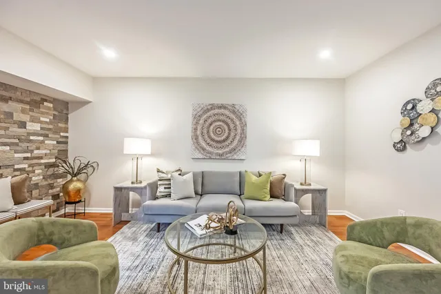 a living room with furniture and a lamp