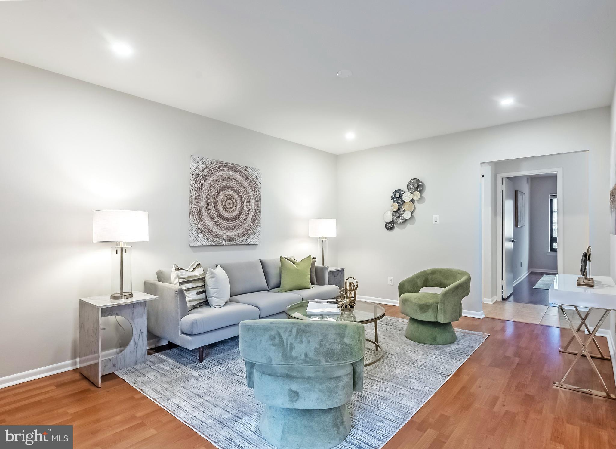 11657 Stoneview Square, Unit 97/22C Reston, VA 20191 - Photo 5 of 28 a living room with furniture and a table