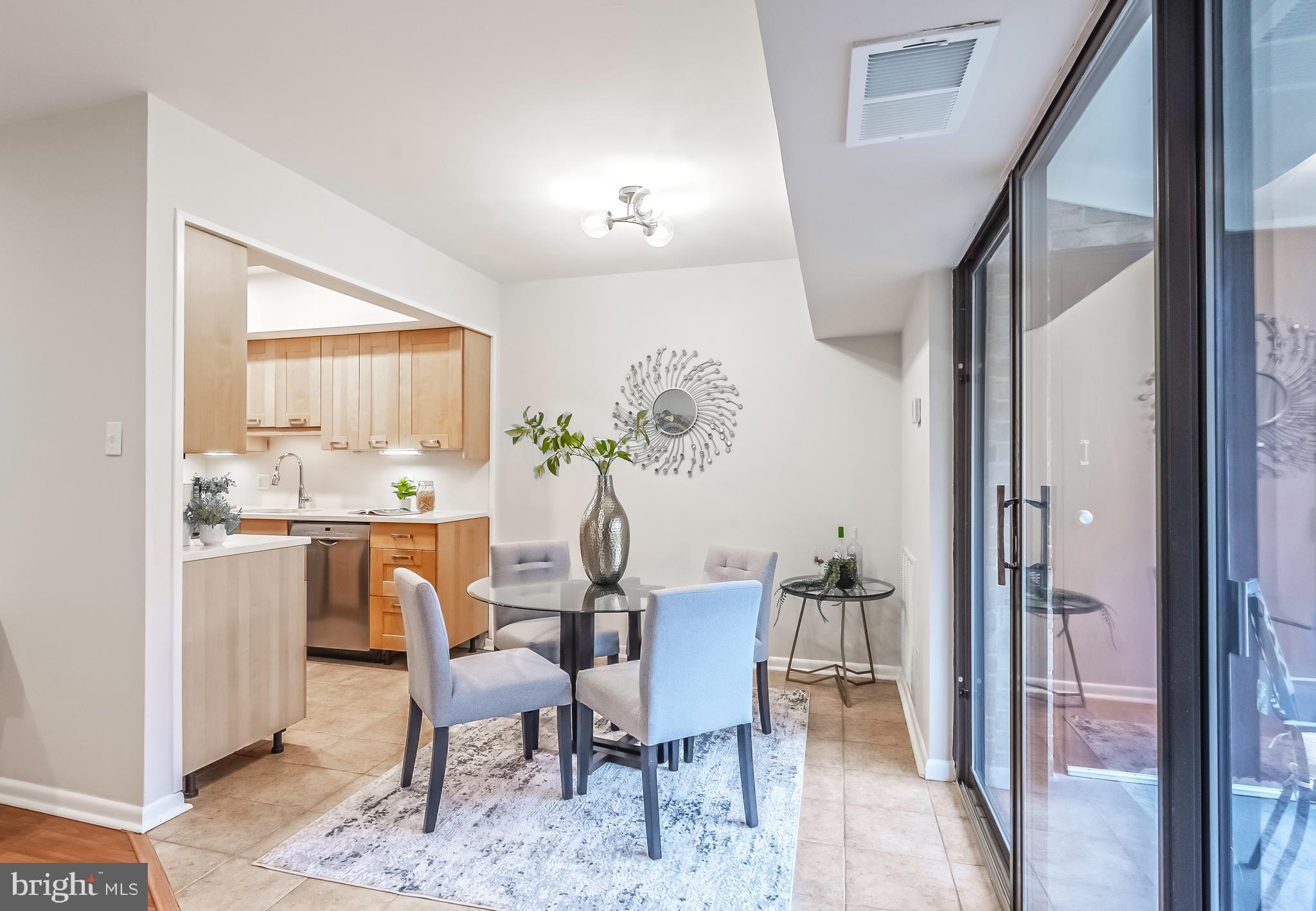 11657 Stoneview Square, Unit 97/22C Reston, VA 20191 - Photo 8 of 28 a view of a dining room with furniture and a potted plant
