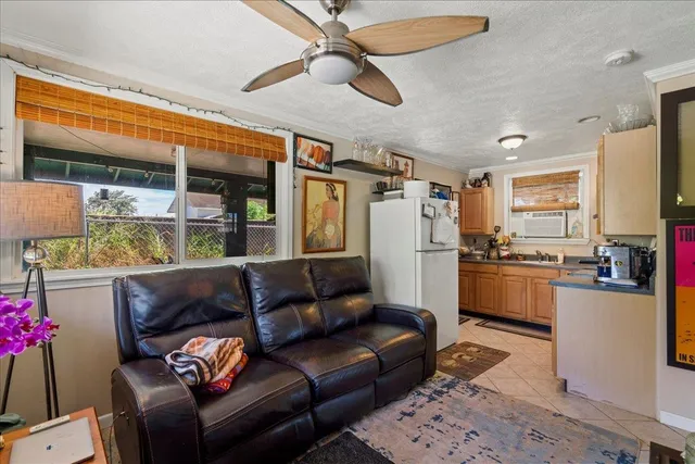 a living room with furniture and kitchen view