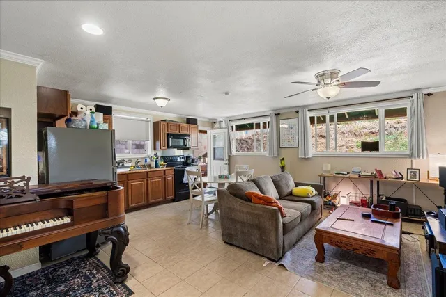 a living room with furniture a piano and a flat screen tv