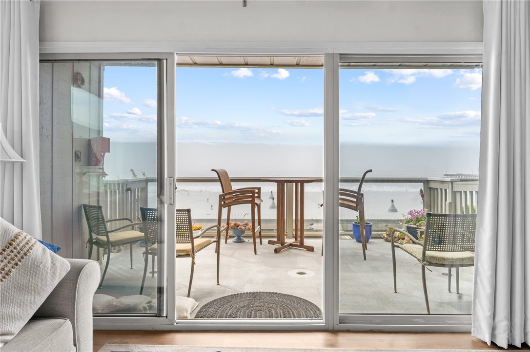 a view of a living room and a dining table with garden view