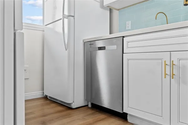 a view of a utility room with closet and mirror